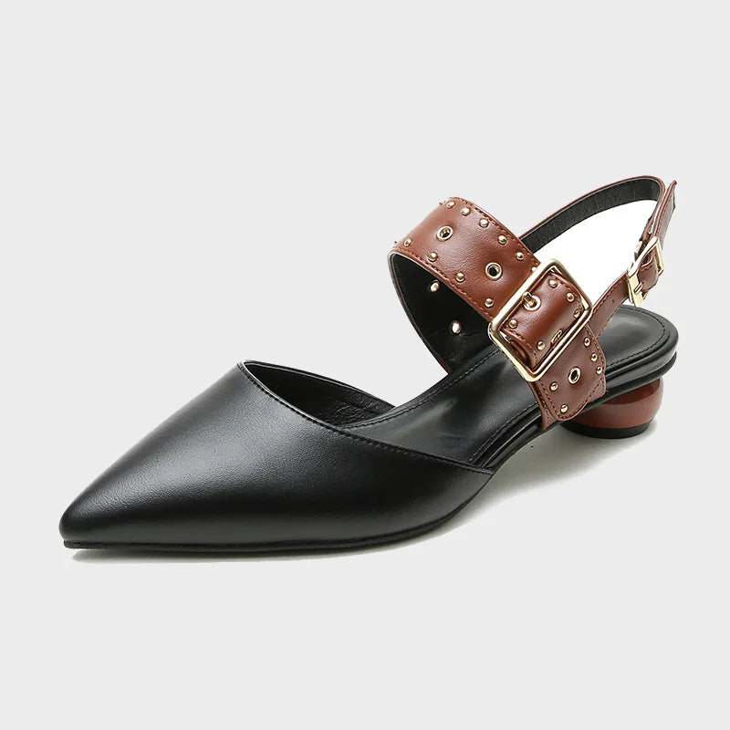 Women's black studded sandals with wide vamp strap, adjustable buckle closure, and edgy metal stud detail