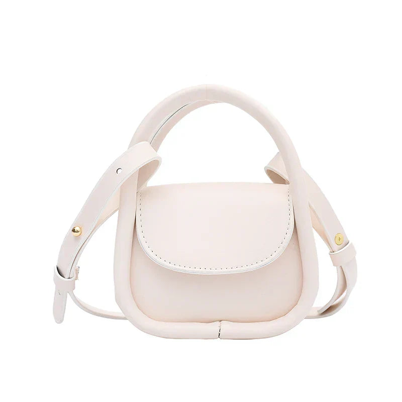 Genuine leather mono crossbody bag with snap closure, adjustable strap, compact city-ready silhouette
