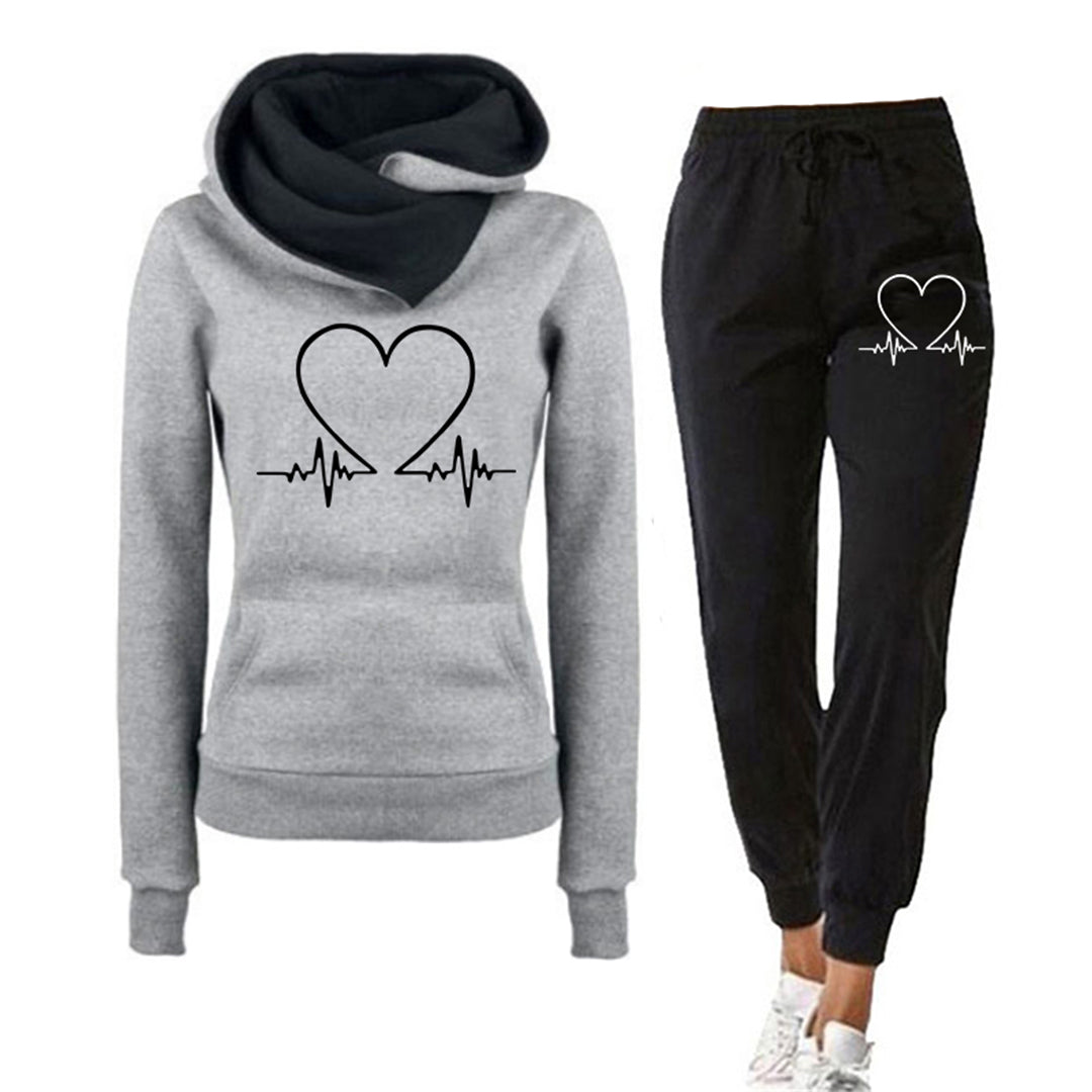 Women's relaxed fit two-piece tracksuit hoodie and joggers set with minimal heart graphic, cozy lounge style