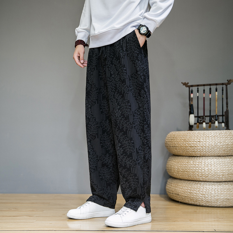 Black relaxed-fit sweatpants with lightweight breathable jacquard fabric and artful floral motif