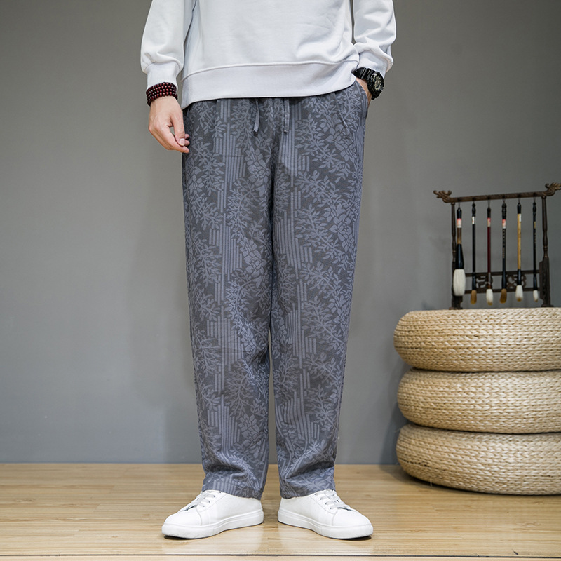 Black relaxed-fit sweatpants with lightweight breathable jacquard fabric and artful floral motif