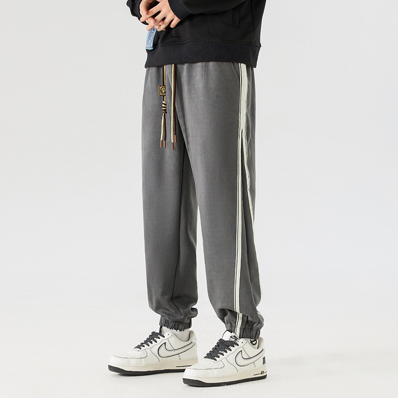 Vintage washed cotton joggers with bold contrast side stripes, retro streetwear cut for men