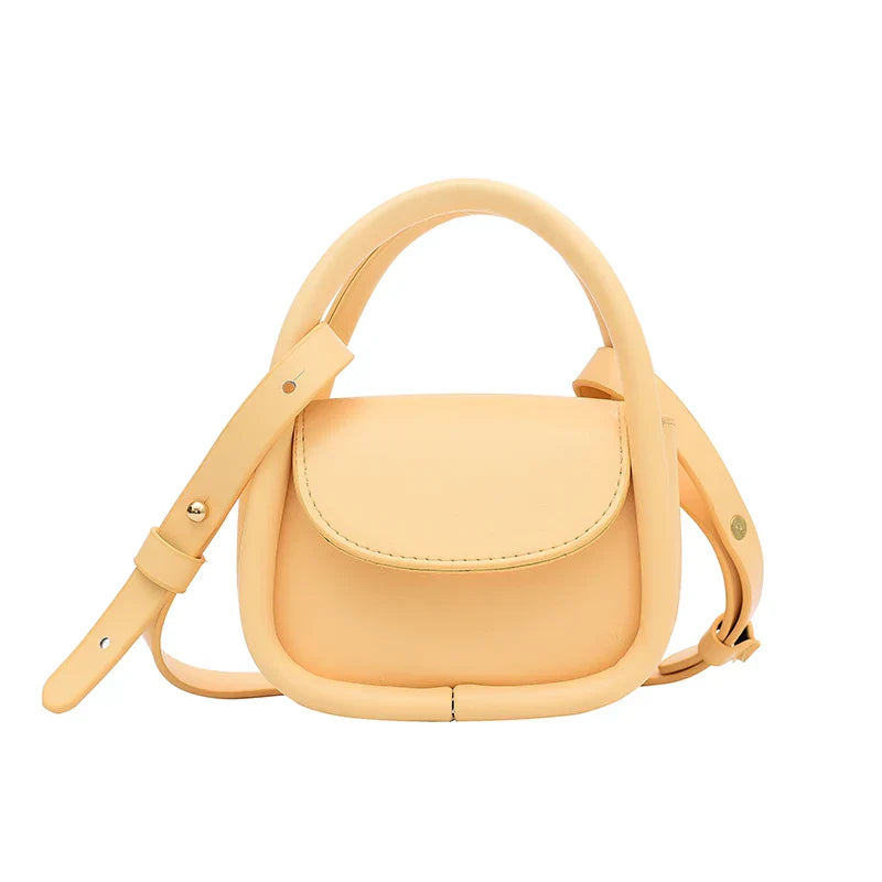 Genuine leather crossbody bag with snap-flap closure, adjustable strap, compact city-ready style
