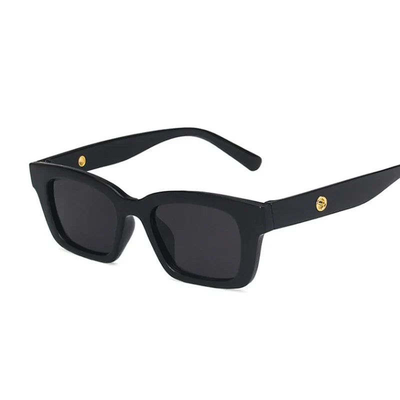 Bold black rectangular wayfarer sunglasses with dark lenses and gold-tone temple accents for sunny days