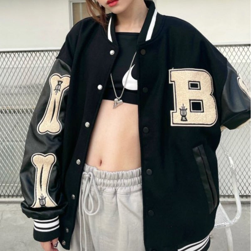 Women's oversized graphic varsity bomber jacket with bold bone sleeve design in retro streetwear style