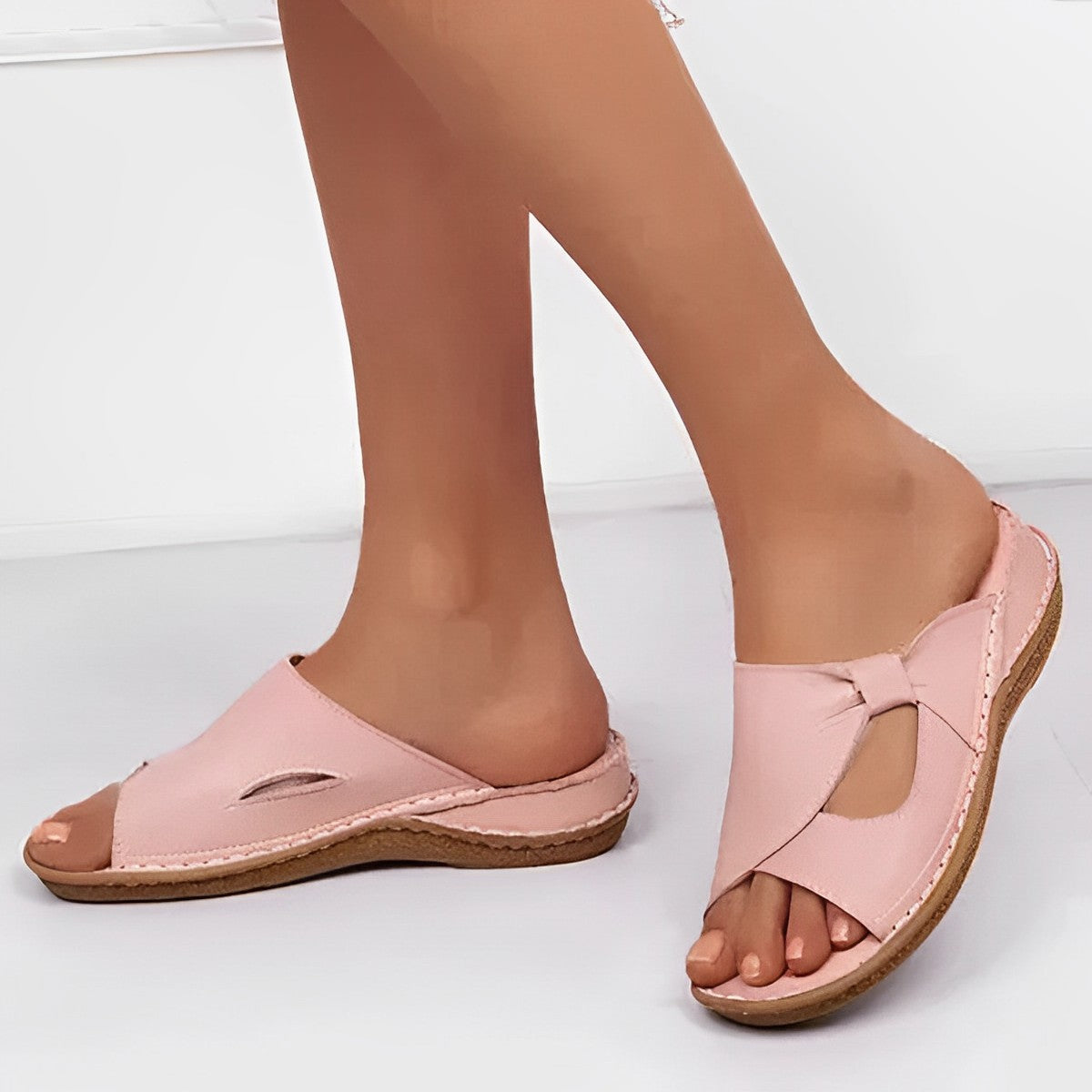 Women's black leather slip-on sandals with contrast stitching and cushioned supportive sole