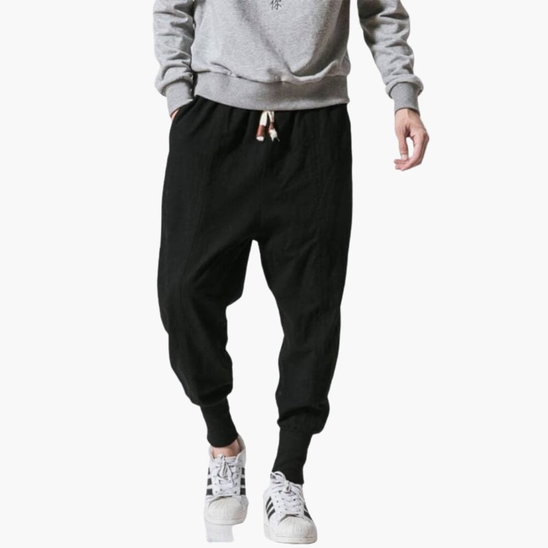 Men's harem jogger pants with drawstring, ribbed cuffs, relaxed wide-cut fit, and side pockets