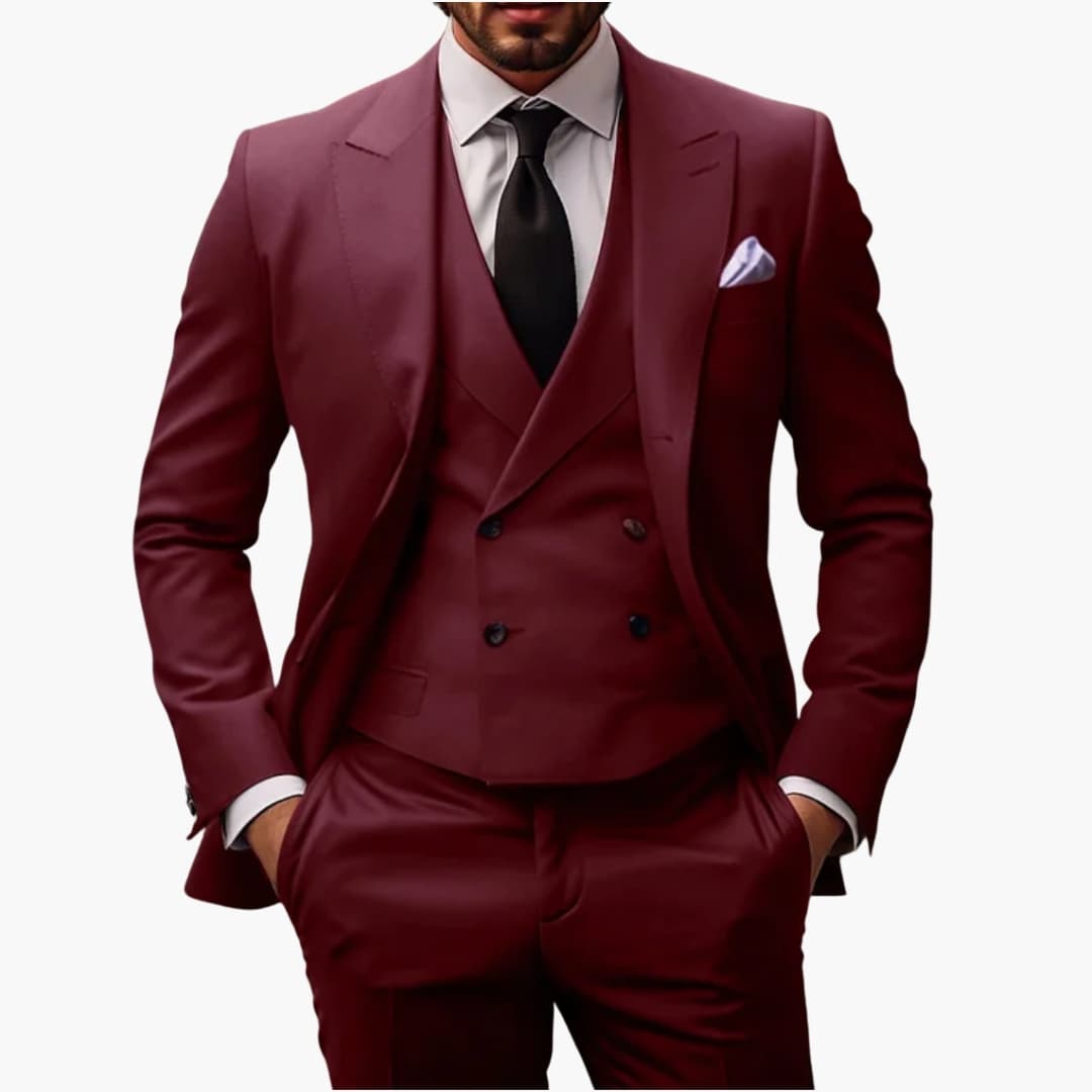 Men's charcoal three-piece structured suit with rising lapel blazer, matching vest, and flat-front trousers