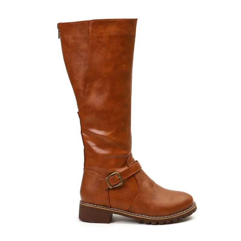 Women's black high-top biker boots with bold chunky heel and edgy belt buckle detail