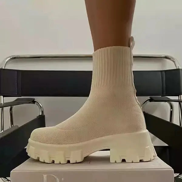 Women's black water-repellent high top sock boots with thick platform heel and mid-calf fit