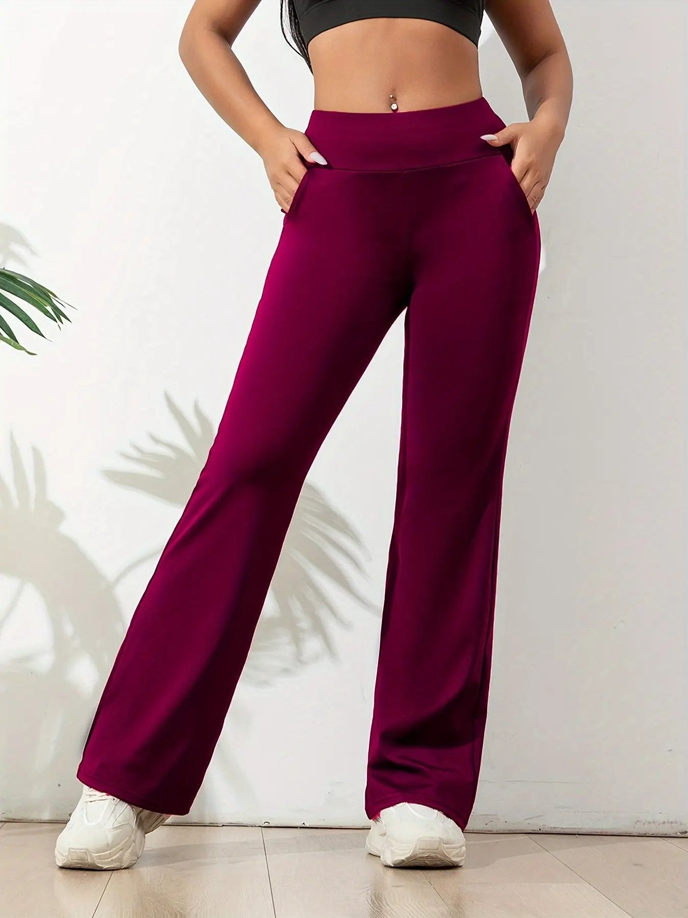 Women's black high waisted yoga pants with wide waistband, four-way stretch, and side pockets
