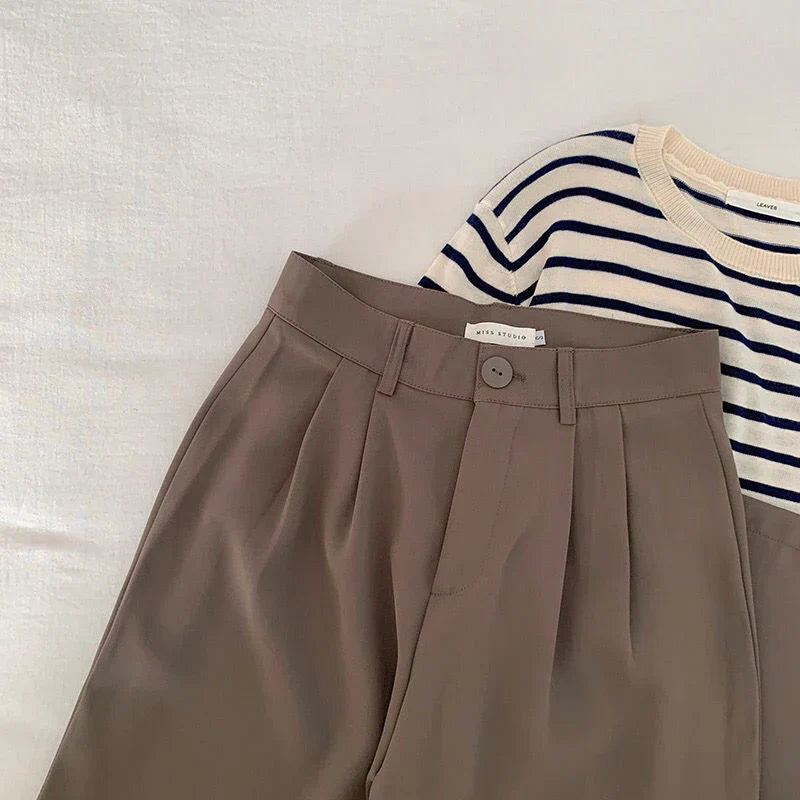 High-waisted women's loose fit suit pants in neutral tone, office workwear with flattering waist detail