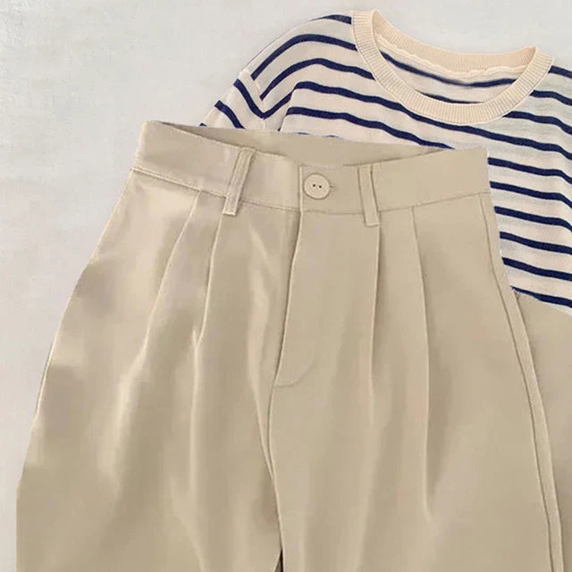 High-waisted women's loose fit suit pants in neutral tone, modern office professional workwear style