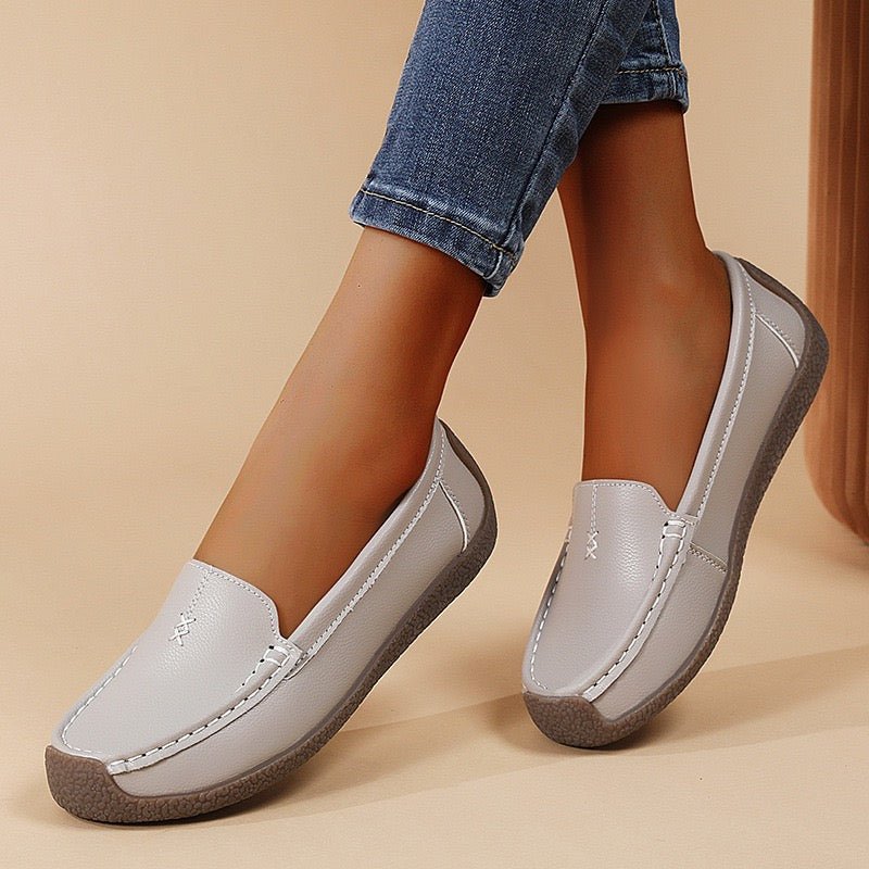 Women's wide-fit slip-on leather loafers with built-in arch support, polished professional style