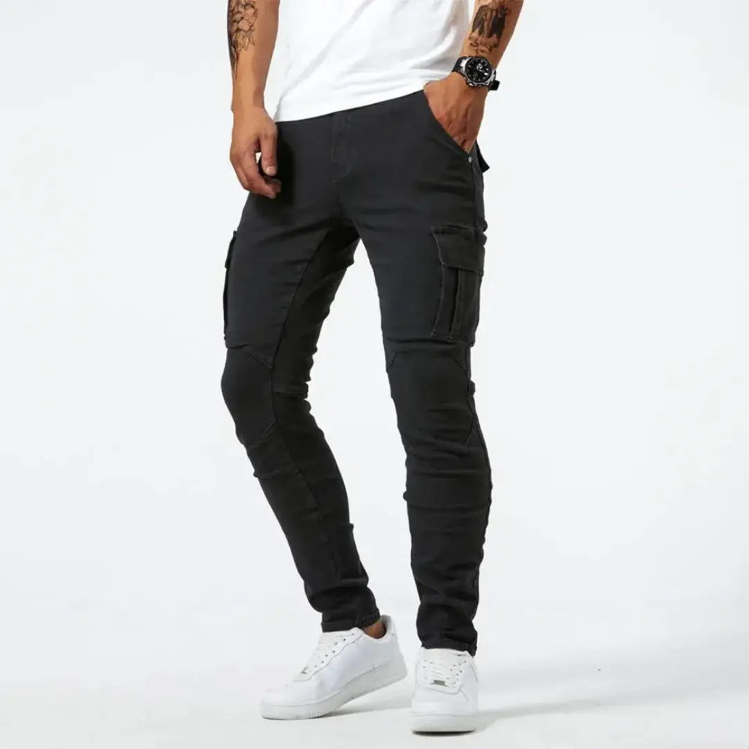 Blue slim-fit denim cargo pants with utility flap pockets and elasticated cuffs for streetwear