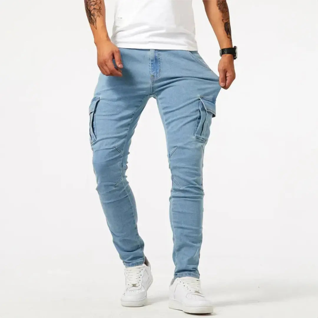 Blue slim fit denim cargo pants with elasticated cuffs and utility flap pockets for streetwear
