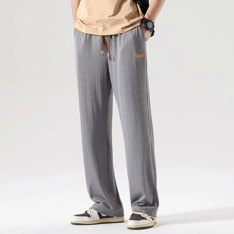 Men's tapered cargo pants with oversized pockets, elastic waistband, streetwear style urban fit