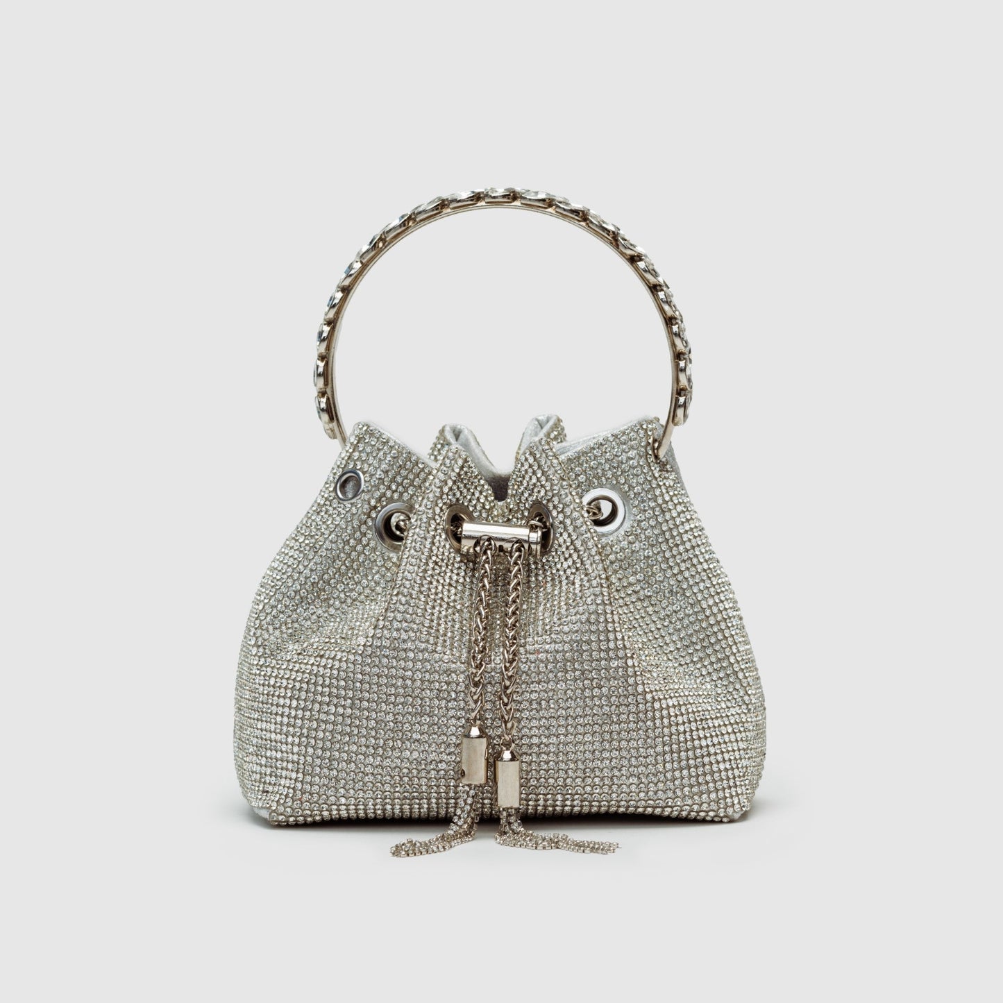 Rhinestone-embellished silver bucket bag crossbody with chain strap, glamorous evening fashion statement