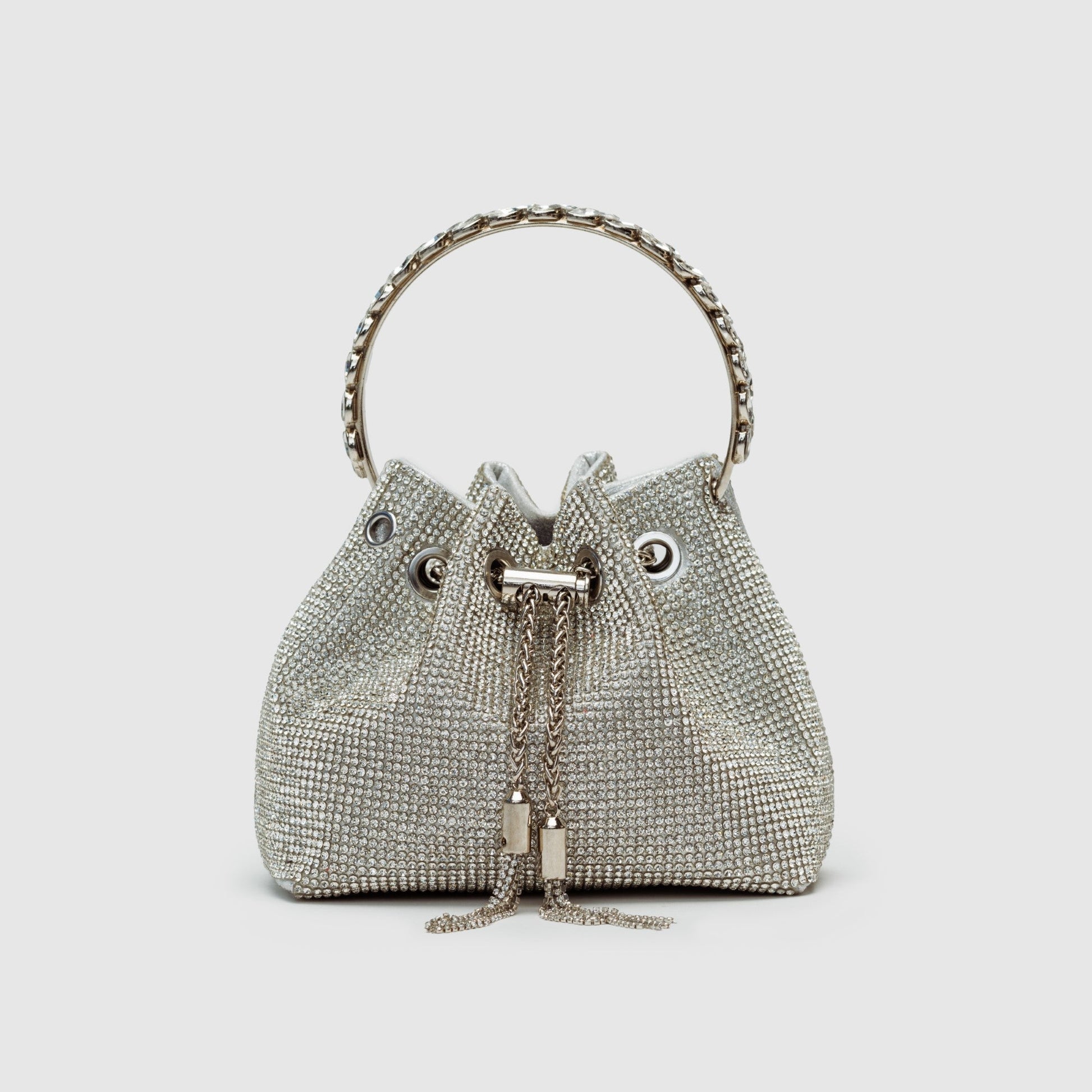 Rhinestone-embellished silver bucket bag crossbody with chain strap, glamorous evening fashion statement