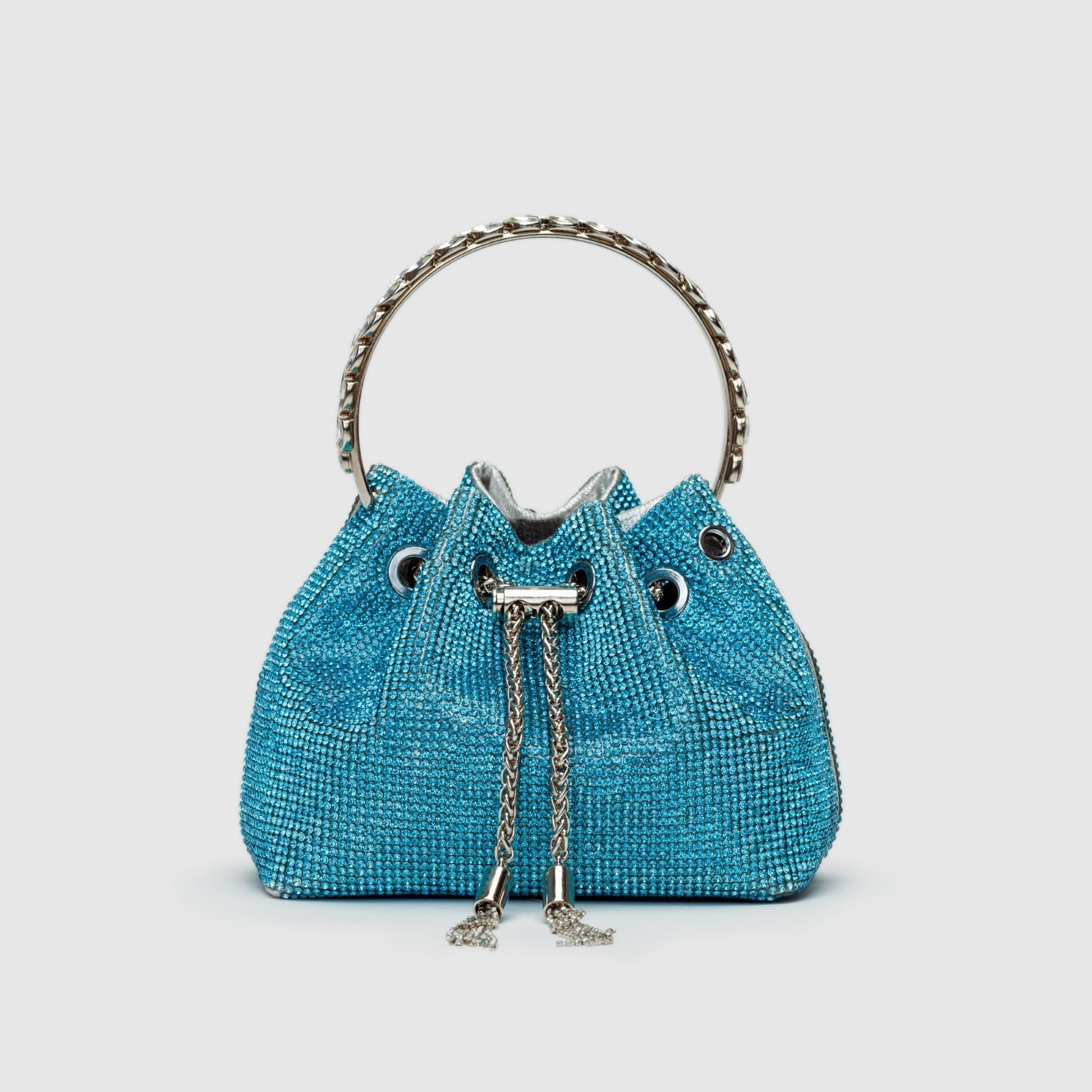 Rhinestone-embellished silver bucket bag with chain crossbody strap, glamorous evening fashion statement