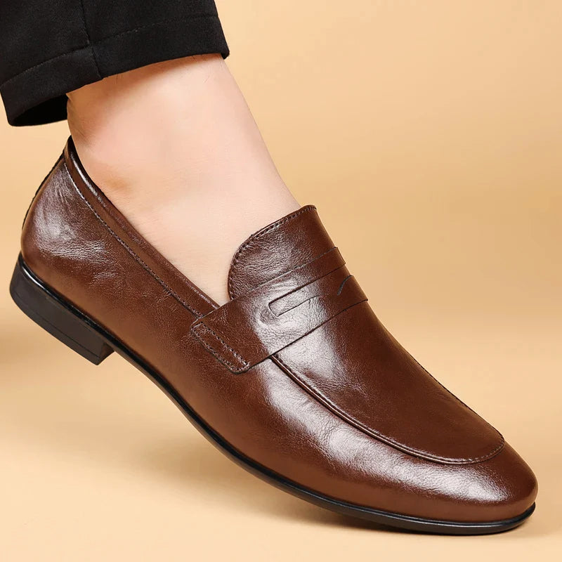 Black full-grain leather slip-on dress loafers with polished handcrafted finish for professionals