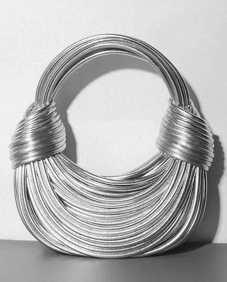 Isla structured beige handbag with knot detail and tubular silhouette for a modern evening look