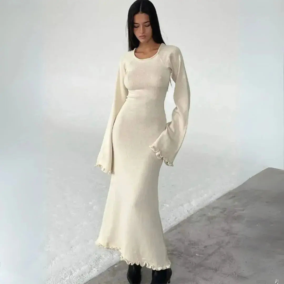 Ivory knit bodycon maxi dress with pleated detail, fluted cuffs, and lettuce hem for winter chic