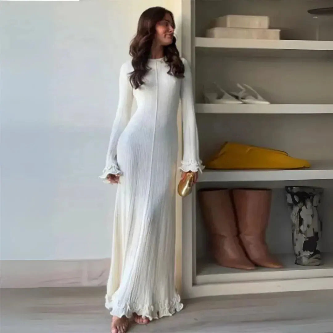 Ivory knit bodycon maxi dress with pleated detail, fluted cuffs, and lettuce hem for winter chic