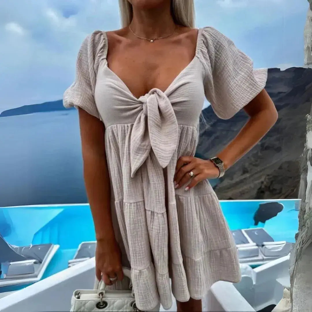 White babydoll mini dress sweetheart neckline front-tie bow tiered skirt flirty summer beach style