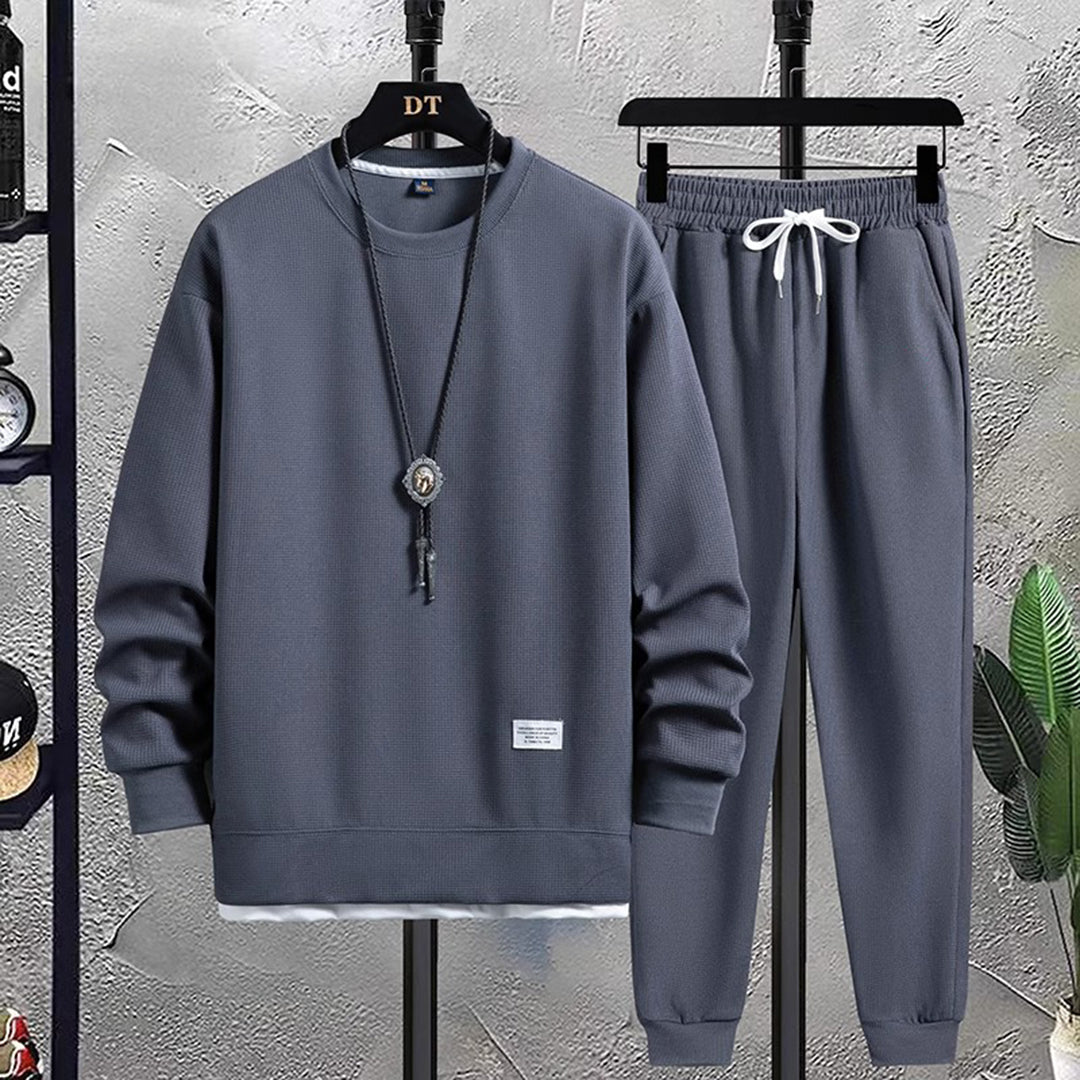 Leo unisex tracksuit set in relaxed-fit sweatshirt and tapered joggers with ribbed streetwear details