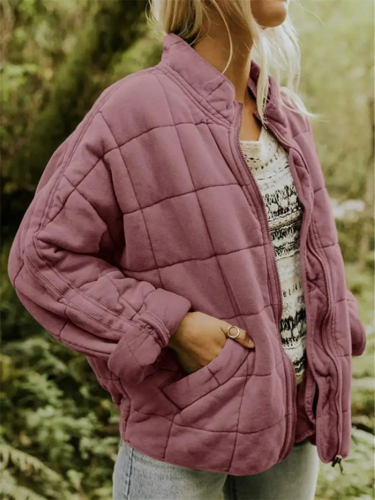Women's loose fit puffer jacket in neutral tone, cozy urban ski style with oversized silhouette