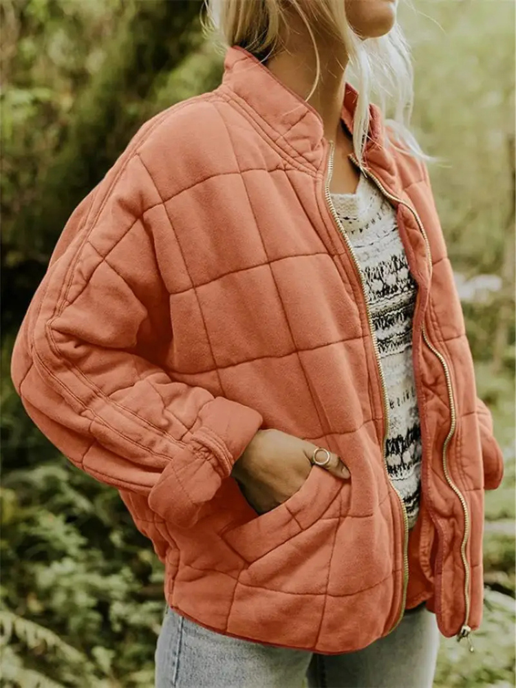 Women's loose fit puffer jacket in cozy winter style, ideal urban ski-inspired outerwear for city days