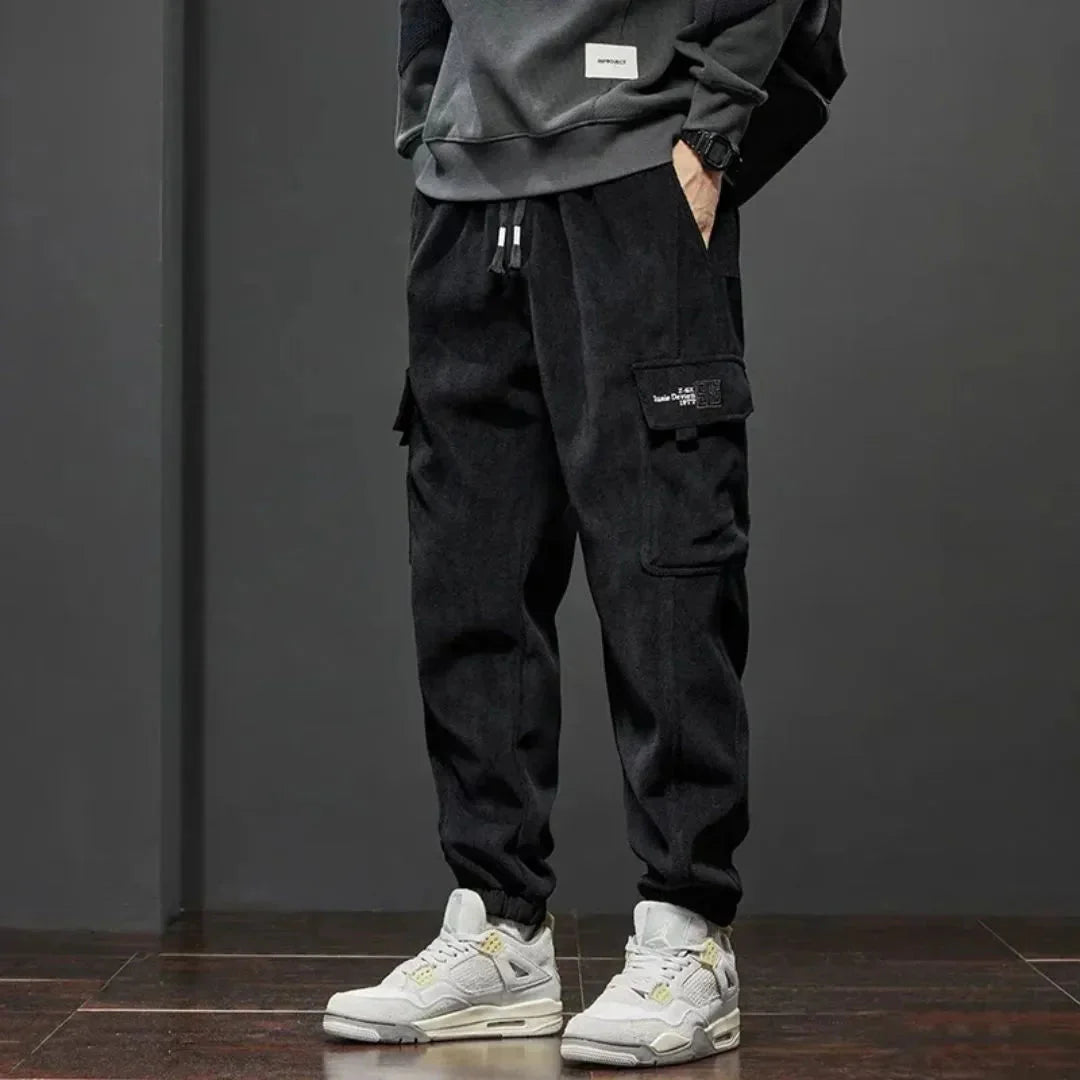 Black thermal fleece-lined tactical cargo pants streetwear cut with dual cargo pockets and ribbed cuffs