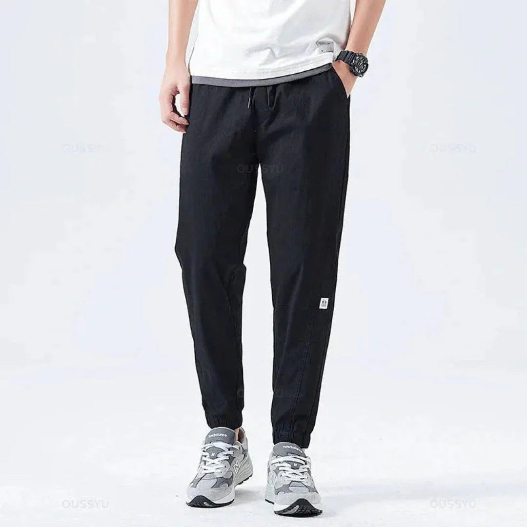 Olive green rugged cargo jogger pants with reinforced stitching and weather-resistant utility pockets