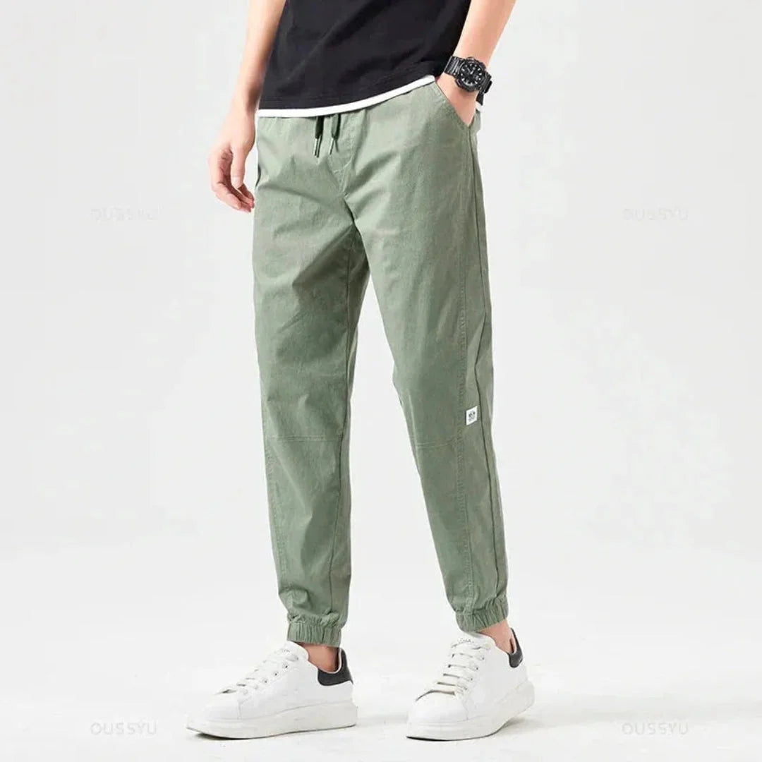 Olive green rugged utility cargo joggers with reinforced stitching and weather-resistant pockets