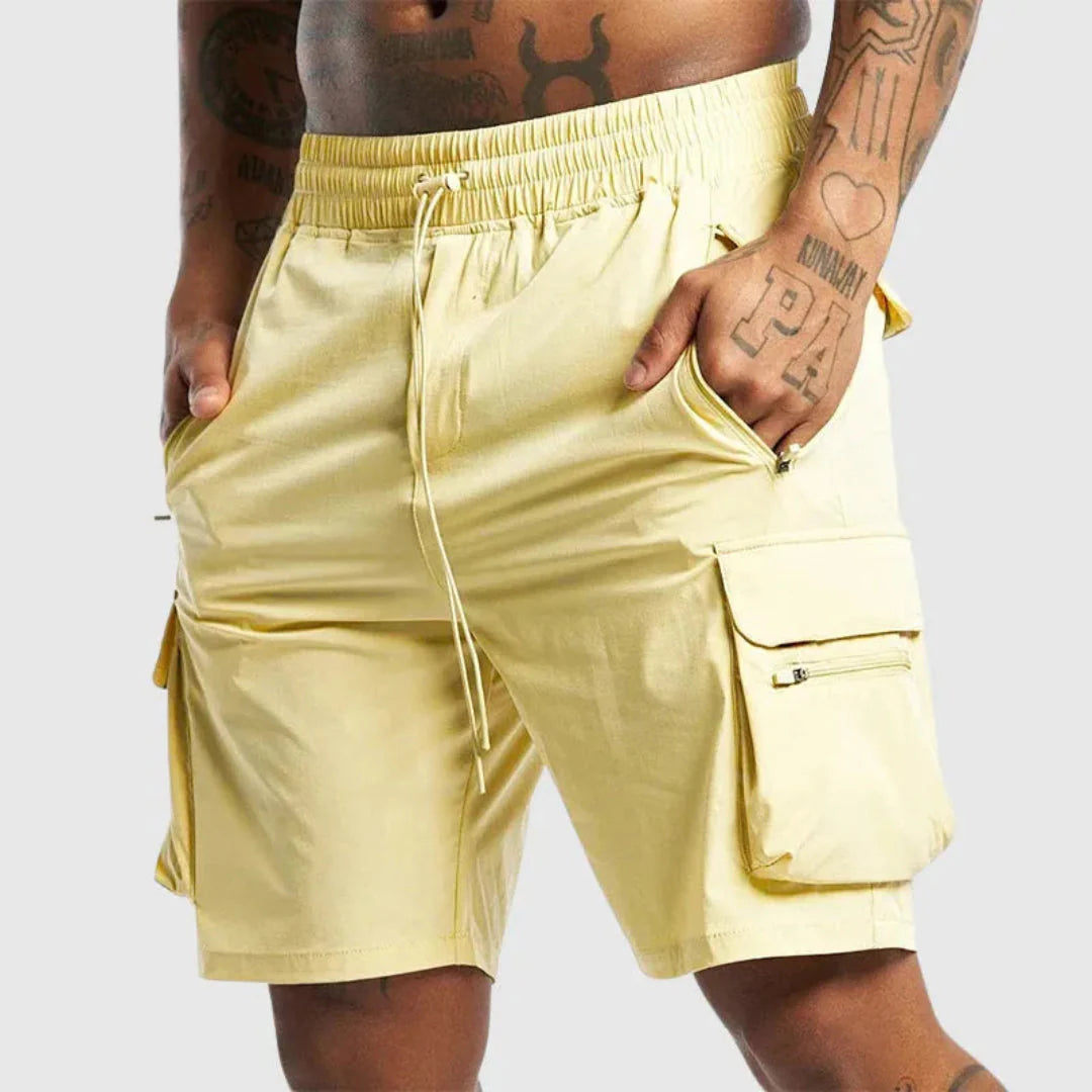 Men's olive green quick-dry nylon cargo shorts with oversized utility pockets and relaxed fit