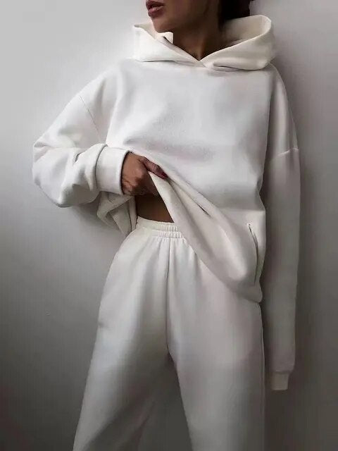 Women's cozy two-piece hoodie and sweatpants set in plush fabric for winter loungewear