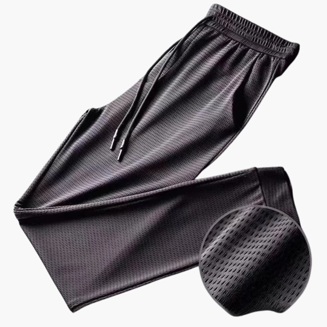Men's gray athletic jogger pants with elastic drawstring waist and secure zipper pockets