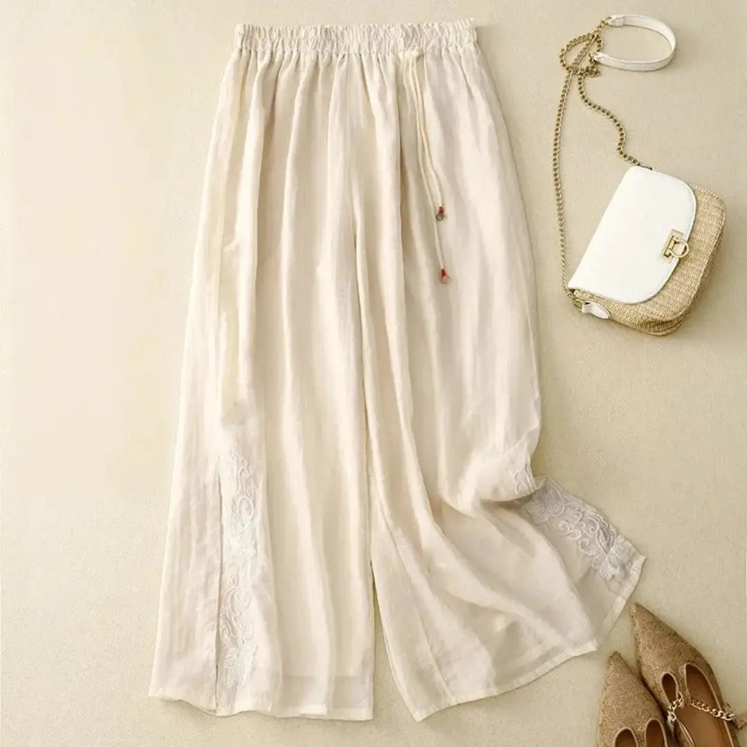 Women's white wide-leg linen pants with tonal embroidery, elastic waist, flowy summer silhouette