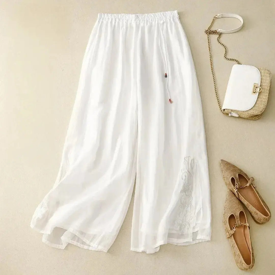 Women's white wide leg linen pants with tonal embroidery detail and elastic waist breezy summer style