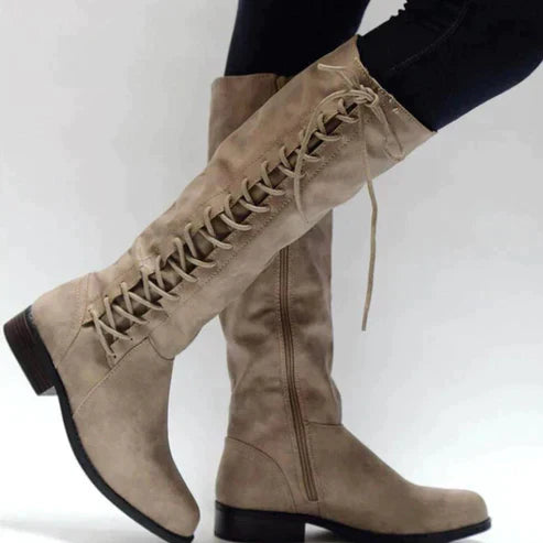 Women's black knee-high lace-up boots with bold front lacing detail for confident everyday style