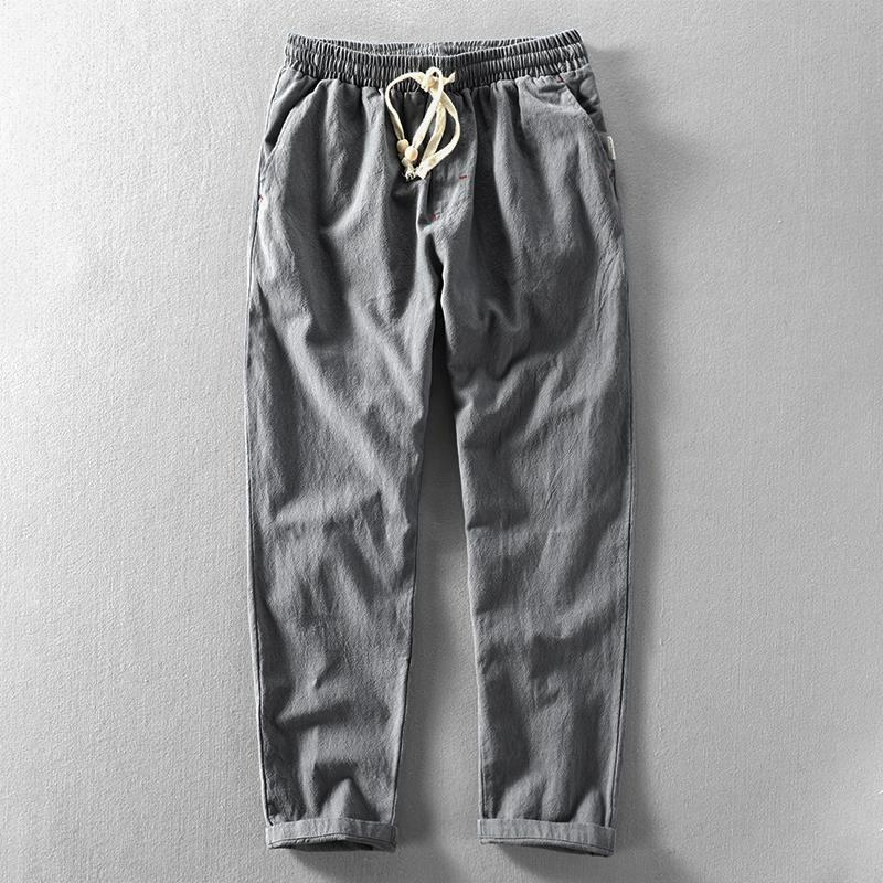 Men's taupe linen blend tapered trousers with elastic waistband and ankle-length slim fit