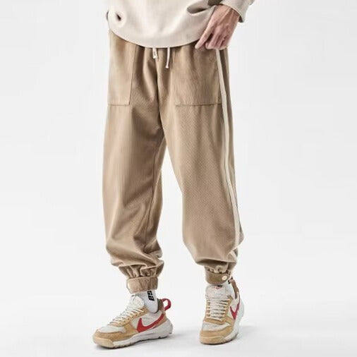 Black relaxed fit streetwear joggers with bold contrast side stripes for all-day comfort