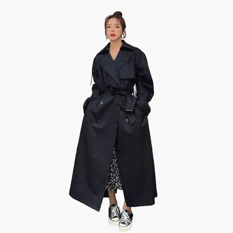 Women's long loose-fit trench coat in neutral tone, oversized silhouette with classic belt detail