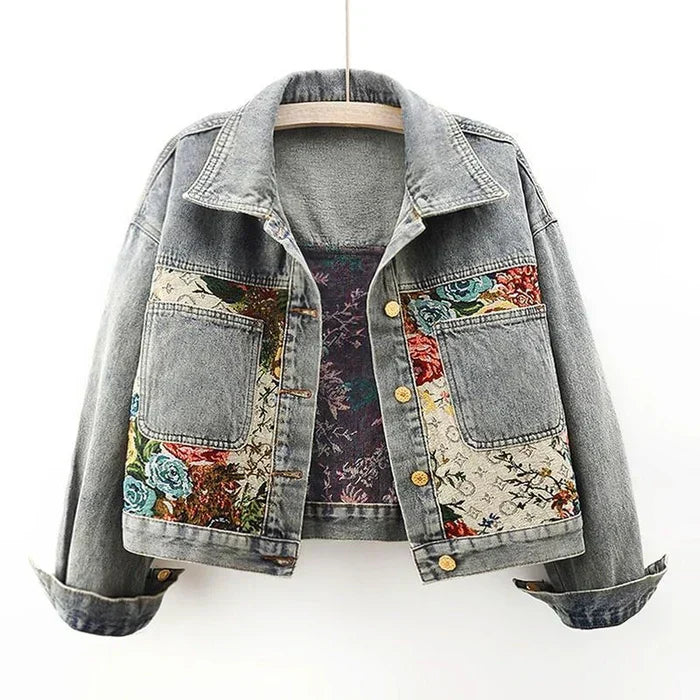Women's short structured blue denim jacket with colorful floral embroidery, boho chic feminine style