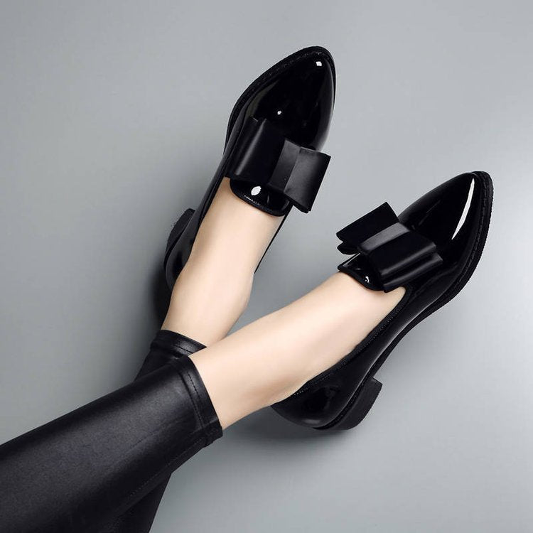 Black patent leather heels by Sofia Amoretti with architectural silhouette for style-forward professionals