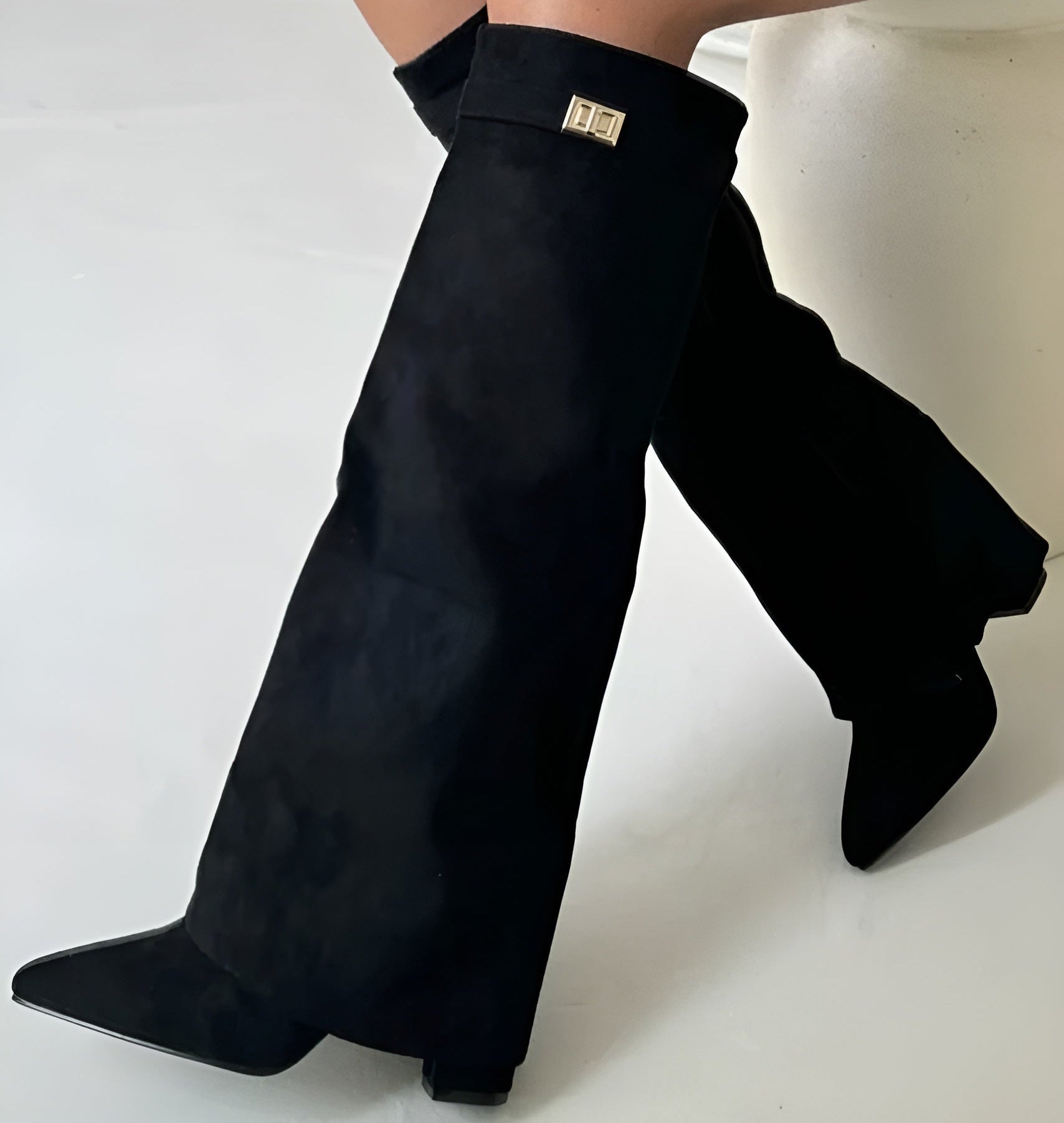 Black knee-high wedge boots for women, structured silhouette with supportive elevated sole