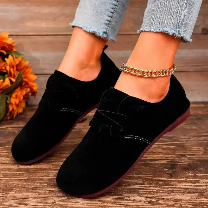 Women's black lace-up flats with soft cushioned sole, round toe, and velvety flock upper