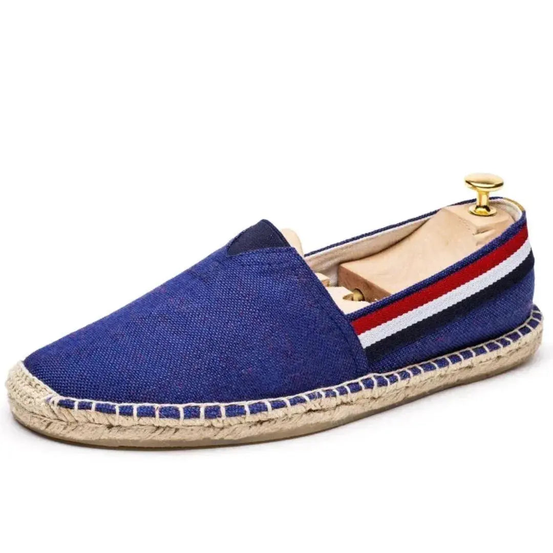 Men's navy canvas loafers with signature stripe detail, breathable lining, and flexible coastal-inspired silhouette