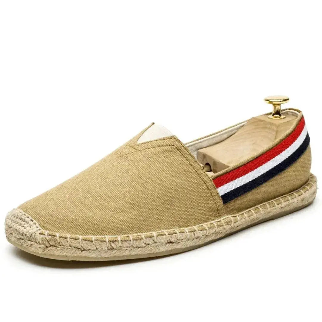 Men's navy canvas loafers with signature stripe detailing, breathable lining, and flexible coastal-inspired comfort